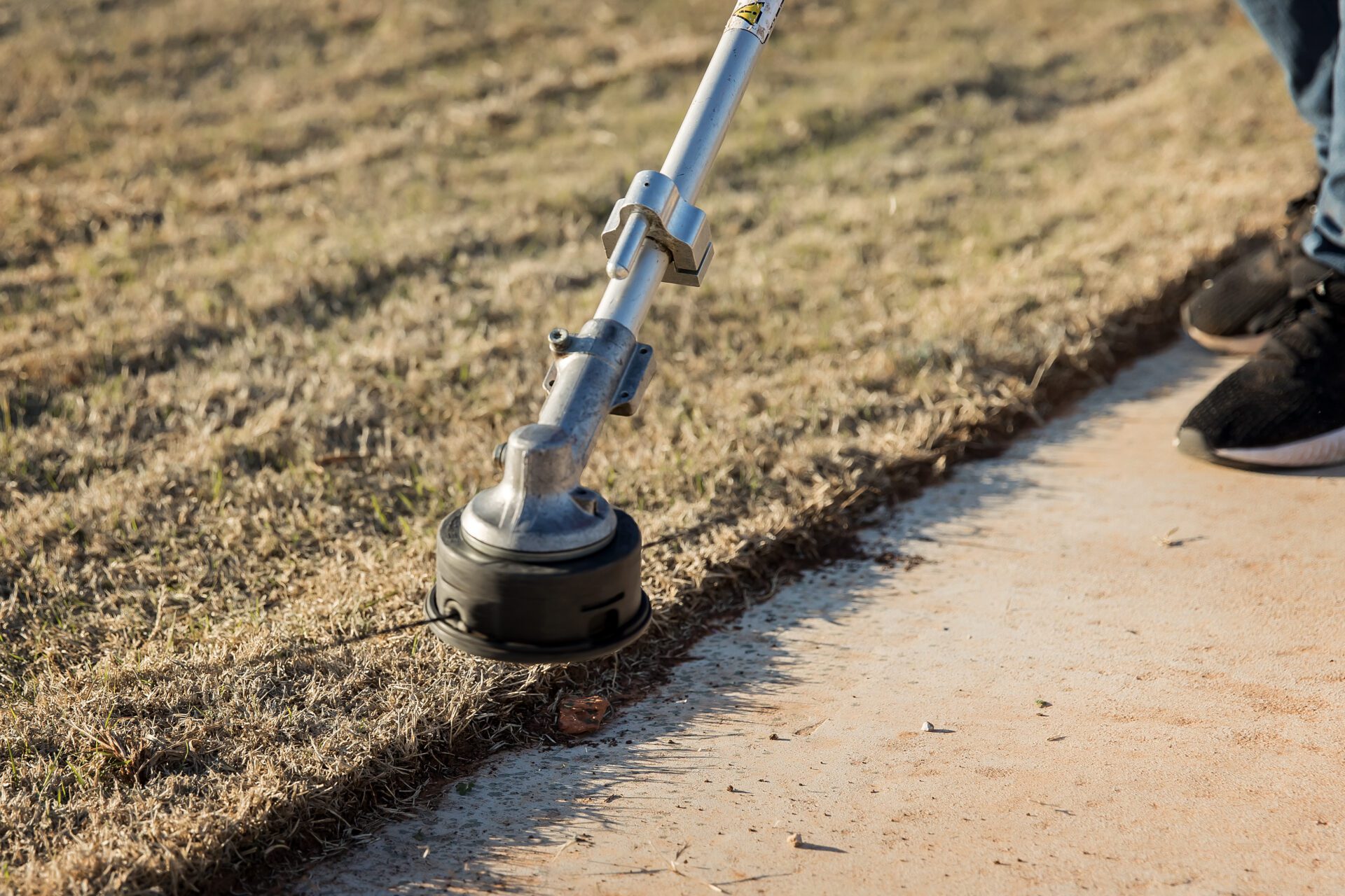 a person holding a lawn mower