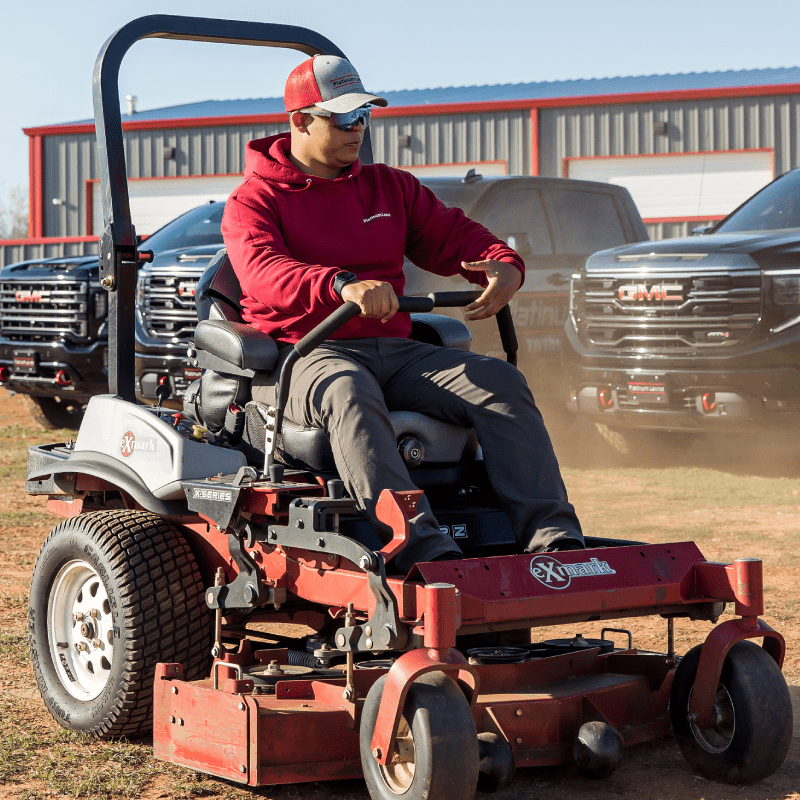 a person driving a lawn mower